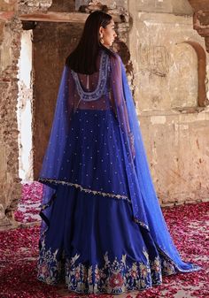 Elevate your style with Blue Embroidered Silk Lehenga Set. Crafted from luxurious habutai silk, this mesmerizing ensemble is adorned with intricate hand embellishments. The stunning blouse dazzles with sequins, pearls, crystals, glass beads, zari, and floral appliqué. Completed with a delicate net dupatta. Perfect for Mehendi, Sangeet ceremonies, or as a wedding guest. Complete the look with statement jewellery and heels for a truly enchanting appearance. Composition : Blouse & Lehenga - Habutai Silk, Dupatta - Net Care: Dry Clean Only and Vacuum Storage This product can be customized for sleeves, length and colour Delivery : 4-6 weeks as the product is hand crafted. Check Size Guide or choose MySize for free customisation (All Sizes above XL can be made at 15% additional cost) For more in Embroidered Chanderi Sets Floor-length, Embroidered Chanderi Floor-length Sets, Silk Saree Set With Intricate Embroidery, Designer Chinon Choli With Sheer Dupatta, Embellished Sets For Eid Reception, Embellished Tissue Silk Saree Set, Embellished Sets For Reception On Eid, Embellished Tissue Silk Choli For Diwali, Festive Embellished Tissue Silk Choli