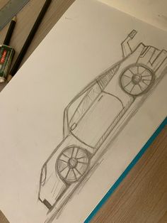 a pencil drawing of a sports car on paper