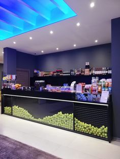 a store filled with lots of different types of fruit and vegetables on display in front of the counter