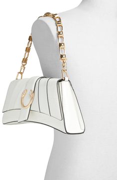 Crystal-embellished serpentine hardware and a chunky chain strap add edge to a trapezoidal shoulder bag with a slightly curved base. Magnetic-snap flap closure Detachable chain strap Interior zip pocket Lined Synthetic Imported Chic Clutch With Branded Hardware, White Chic Flap Bag With Chain Strap, Elegant Shoulder Bag With Gold-tone Hardware And Chain Link, Chic White Flap Bag With Chain Strap, Chic Flap Bag With Chain Strap, Chic Crossbody Flap Bag With Chain, Chic Flap Bag With Chain Crossbody, Chic Satchel Clutch With Chain Strap, Elegant Bags With Metal Hardware And Chain Link Shape