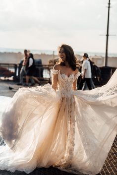 a woman in a wedding dress on the beach