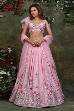 Pink lehenga with blue hues, 3D embroidery, hand embroidered with mirrors, badla thread and stones. Comes  with embroidered blouse with ruffle sleeve and sheer net dupatta.
Component: 3
Pattern: Embroidered
Type Of Work: Mirror and Badla Work
Neckline: V-neck
Sleeve Type: Asymmetric
Fabric: Lehenga: Raw Silk; Blouse: Raw Silk and Organza; Dupatta: Net
Color: Pink
Other Details: 
One sided sleeve
One sided ruffle sleeve
Back tie-ups
Occasion: Destination Wedding - Aza Fashions Pink Lehenga Blouse, Dupatta Embroidery, Lehenga And Blouse, Mehendi Outfit, Thread Beads, Indian Fashion Trends, Designer Bridal Lehenga, Pink Lehenga, Indian Dresses Traditional