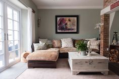 a living room filled with furniture and a fire place in front of a painting on the wall