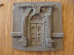 a clay sculpture of an entrance to a building