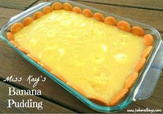 a casserole dish with banana pudding in it on a wooden table top and the words miss kay's banana pudding