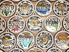 many different badges are shown on a wooden surface with the words grand canyon written in them