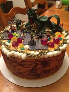 a decorated cake sitting on top of a wooden table