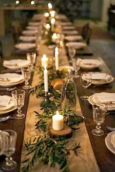 Even at a large gathering, low lighting and minimal decor accents can create a lovely, intimate space. Table With Candles, Centerpiece Candles, Simple Table Settings, Rustic Wedding Decorations, Ultimate Christmas, Elegant Dinner, Green Candle, Long Table, Christmas Table Settings