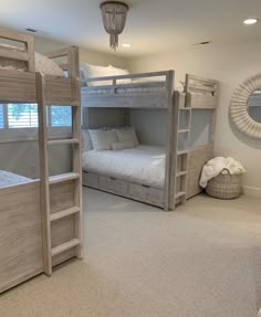 a bedroom with two bunk beds and a ladder to the second bed is shown in this image