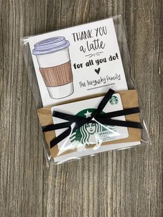 the starbucks gift card is wrapped in brown paper and has a black ribbon around it