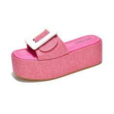 a pair of pink shoes with a white buckle