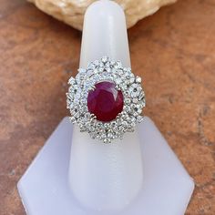 18KT White Gold Oval Ruby + Pave Diamond ring Size 8 Can be resized for an additional fee Large Statement Ring Lovely intricate design This an absolutely lovely attention getting piece! Round and Baguette Diamonds with Oval Faceted Ruby Ring. Approx 4.83 CT Ruby 10.7 x 9.9x 5.7 mm 2.20 CT Diamond Approx 9.8 grams 18KT Stamped Abrasions to the Ruby, which could be polished out by a stone cutter. We can quote for that if need b3, but this ring is so pretty, it really does not need. Check out all o White Oval Ruby Ring, Oval White Ruby Ring, Gia Certified Fine Jewelry Ruby Ring, Elegant White Oval Ruby Ring, Gia Certified Ruby Ring For Wedding, Ballerina Ring, Saint Jewelry, Anniversary Wedding Band, Pave Diamond Ring