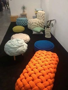 several knitted chairs and stools are on display