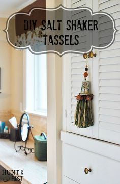 there is a white cabinet with tassels hanging from it's sides and the words diy salt shaker tassels above it