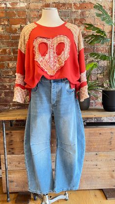 Get ready for Fall in our red peace and love top! Adorable mixed fabric heart shaped peace sign is perfect for our boho ladies. Would be perfect for a a fun game day look whn you want something a little more unique. Pairs great with our barrel jeans or our embroidered yoga flares! Looks cute with a front tuck, a side knit, or loose and flowy. Oversized fit - read measurements before buying. Fabric 100% Cotton Measurements taken flat S- Bust 24" Length 27" M- Bust 25" Length 27.5" L- Bust 26" Length 28" Boho Hippie Outfits, Barrel Jeans, Rebecca James, Upcycle Sweatshirt, Get Ready For Fall, Boho Jeans, Front Tuck, Fabric Heart, Funky Outfits