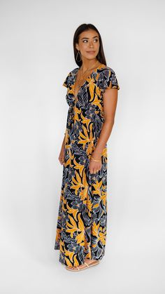 Complement the warmth of summer with an easy summer maxi dress to show your strong and feminine side. Our Leilani Maxi Dress subtly slims you down with its cap-sleeved, deep V-neckline, while the self-tying waist accentuates your curves effortlessly. Don't miss the side slits that'll let sashay around the city or the coast looking polished and relaxed at the same time. ** Our Model is 5'8" and wearing a size SMALL. ** *Cap Sleeves *V neck *Maxi Dress *Side slits *Front tie details *100% Rayon Summer Maxi Dress With Tie Waist, Beach Maxi Dress With Tie Waist And Surplice Neckline, Vacation Maxi Dress With Tie Waist, Vacation Tie-waist Maxi Dress, Tie Waist Sundress Maxi Dress, Sundress Maxi Dress With Tie Waist, Surplice Neckline Maxi Dress With Tie Waist For Vacation, Sundress Style Maxi Dress With Tie Waist, Floral Print Maxi Wrap Dress For Beach