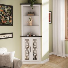 a living room with a white bookcase and green walls