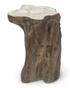 a piece of wood that is shaped like a tree stump with some white rocks on it