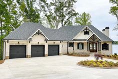 a large house with two garages in front of it