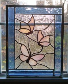 a stained glass window with three butterflies on it