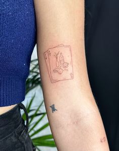 a woman's arm with a tattoo on it that has an image of a cat