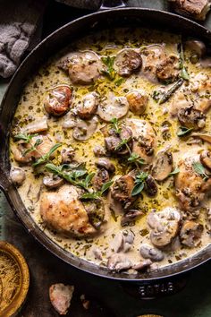 a skillet filled with chicken and mushrooms