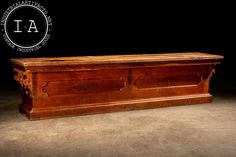 an old wooden trunk sitting on top of a cement floor in front of a black background