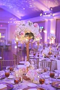 the centerpieces are adorned with flowers and candles for an elegant touch to the tables