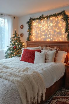 a bedroom decorated for christmas with lights on the headboard and trees in the window