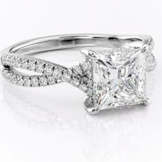 a princess cut diamond ring with two rows of diamonds on the band