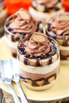 three desserts with chocolate frosting and peanut butter on top are sitting on a plate