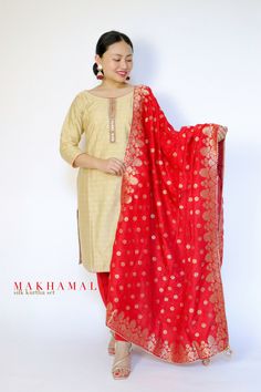 Soft golden straight kurta set with Banarasi silk red dupatta. Available in only size 38 (UK: 10-12) It has hand emb. details on the tops . Model: UK size 8, Height: 5'2 . If interested please message us.  -Makhamali Bollywood Style Jamawar Kurta With Gota Work, Festive Bollywood Unstitched Slub Silk Suit, Fitted Gold Kurta With Gota Work, Festive Slub Silk Salwar Kameez With Gota Work, Red Chanderi Straight Kurta, Traditional Gold Jamawar Kurta, Festive Unstitched Jamawar Suit With Gota Work, Festive Jamawar Anarkali Set With Gota Work, Festive Jamawar Kurta With Zari Work