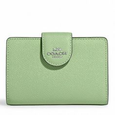 Elevate your everyday essentials with the Coach Women's Medium Corner Zip Leather Wallet. Crafted from durable crossgrain leather, this wallet combines style with practicality. Featuring seven credit card slots, a bill compartment, an ID window, and a zip coin pocket, it's perfect for keeping your essentials organized. Size: 5" (L) x 3 1/2" (H) x 1/2" (W).  Color: Green.  Gender: female.  Age Group: adult. Compact Green Wallet With Card Slots, Compact Green Wallet For Travel, Compact Green Travel Wallet, Classic Green Wallet For Daily Use, Versatile Green Wallets With Rfid Blocking, Classic Green Wallet With Rfid Blocking, Green Classic Wallet With Rfid Blocking, Classic Green Trifold Wallet, Classic Green Bifold Wallet