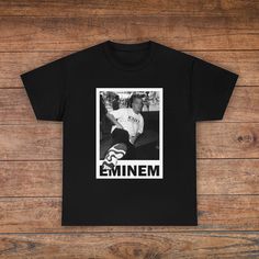 a black t - shirt with an image of emiem on it