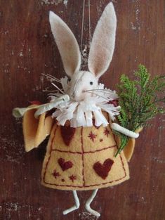 a stuffed animal hanging from the side of a wooden wall