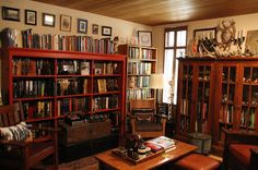 a living room filled with lots of books and furniture