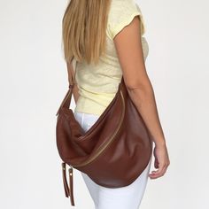 Featuring our popular leather sling bag in brown color made from the softest genuine Italian leathers. This large crossbody fanny pack stands out for the quality of its leather, for the capacity and for the stylish buckle used on the leather strap. It is a 3 style bum bag as you can wear it as a crossbody bag, as a shoulder bag and as a backpack. The large compartment is ideal to fit all your daily essentials like a water bottle, a make up case, wallet , phone, notebook and more. Ideal for trave Large Capacity Leather Belt Bag For Everyday Use, Versatile Brown Hobo Bag With Zipper Pocket, Leather Belt Bag With Large Capacity, Versatile Brown Backpack Shoulder Bag, Brown Crossbody Hobo Bag With Zipper Pocket, Brown Tote Belt Bag For Travel, Brown Shoulder Belt Bag, Brown Soft Leather Backpack Hobo Bag, Brown Soft Leather Hobo Backpack Bag