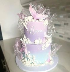 a purple and white cake with flowers on it