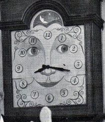 an old black and white photo of a clock with faces on it