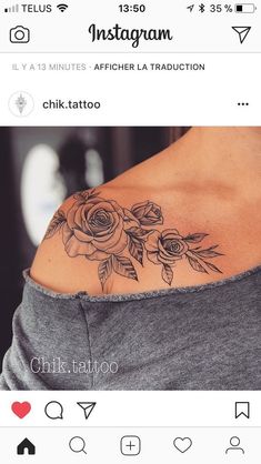 the back of a woman's shoulder with roses on it and leaves in the middle