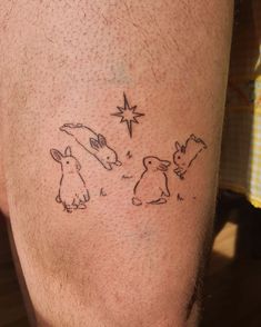 a man's leg with tattoos on his legs and some animals drawn on it