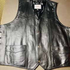 Rev Up Your Style With This Nwot Leather Motorcycle Biker Vest From Side Lace Inner Conceal Pockets. Crafted From High-Quality Leather, This Vest Features A Classic Black Color With Snap Closure And Lace-Up Sides That Can Adjust Sizing. The V-Shape Collar Style And Industrial Polyester Lining Add To Its Stylish Appeal, While The Pockets Provide Ample Space For Your Essentials. Perfect For Travel Or Casual Occasions, This Vest Is A Must-Have For Any Biker Or Motorcycle Enthusiast. Its Lightweight Classic Black Vest With Pockets, Biker Vest, Leather Vest, High Quality Leather, V Shape, Classic Black, Snap Closure, Collar Style, Black Color