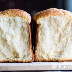 two pieces of bread sitting on top of a cutting board