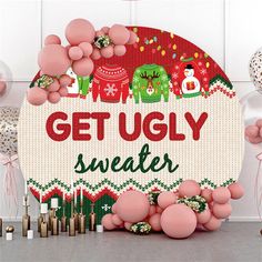 an ugly sweater sign surrounded by balloons and other holiday decorations in front of a white wall