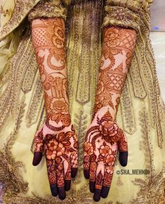 the hands are decorated with henna designs