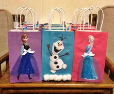 three bags with frozen princesses on them are sitting on a wooden chair in front of some chairs