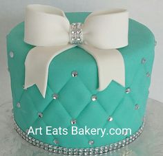 a green cake with white bows on top