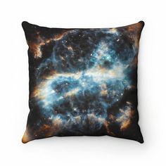 a pillow with an image of the galactic star cluster in blue and orange colors, on a white background