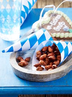 there is a plate with cookies and candy in it on the table next to a glass of water