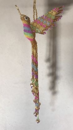 a colorful bird ornament hanging from a chain